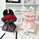 Two bunny-shaped floral bouquets, one black with red roses, the other pink with pink roses.