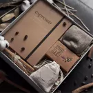 Espressiano gift set with notebook, socks, small bag, and coffee beans in a box.