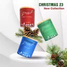 Three Christmas scented candles in red, green, and blue jars with pinecones and festive decorations.