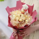 Chocolate bouquet with a teddy bear topper and Ferrero Rocher chocolates.