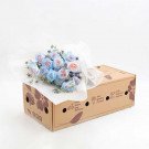Bouquet of blue and pink roses on a delivery box.
