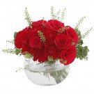 A red rose and carnation arrangement in a glass bowl.