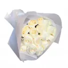 Bouquet of 15 white roses wrapped in white paper.