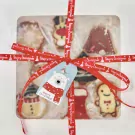 Christmas cookies in gift box with red ribbon and polar bear tag.