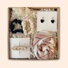 Gift box with scrunchies, earrings, hair clip, and scarf.