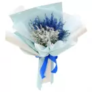 Bouquet of blue and silver dried flowers wrapped in pale blue paper and tied with a blue ribbon.
