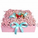 Pink baby's breath and strawberries in a pink box with light blue bows.