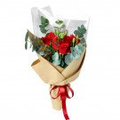 Brick red roses and carnations wrapped in brown paper and white tissue, tied with a red ribbon.