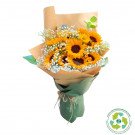 Bouquet of sunflowers and baby's breath in brown and green paper wrapping.