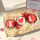 "I Heart U" gift set with three scented candles and red flowers in a box.