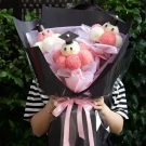 Graduation bouquet of white ping pong chrysanthemums and pink pom-poms, with graduation caps.