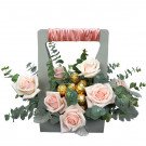 Pink roses and Ferrero Rocher chocolates arranged in a grey gift box with ribbon handle.