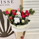 Christmas bouquet with red roses, pine branches, festive ornaments, and a snowman figure.