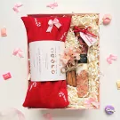 Valentine's gift set with red herbal pillow, pink salt, cinnamon sticks, dried flowers, and "Be my Valentine" tag.