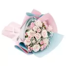 Bouquet of pink and white roses with baby's breath, wrapped in pink and blue paper.