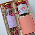 Gift set with rose tea, honey, and mug.
