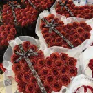 Heart-shaped bouquets of red glitter roses with Chanel ribbons.