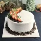 White cake with strawberries and chocolate shavings.