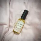 A room spray bottle labeled "Goodnight Darling" rests on a soft pink fabric.