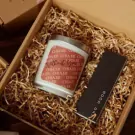 Candle in gift box with shredded paper, has text "Missing You" and a card that says "GOOD DAY".