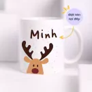 Ceramic mug with a reindeer design and the name "Minh" printed on it.