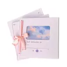 Pink ribbon tied around a pale purple notebook with a sky photo and "Just between us" text.