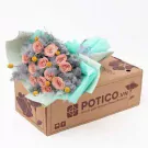 Bouquet of pink cappuccino roses, yellow craspedia, and grey foliage in a gift box.