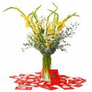 Yellow gladiolus, roses, and eucalyptus in a vase with red envelopes on a white background.