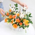 Orange roses and bunny decorations in a white basket.