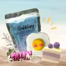 Bath salts, a fried egg shaped bath bomb, and a blueberry cake shaped bath bomb.