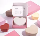Heart-shaped lunchboxes in various colors on a white background.