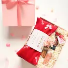 Valentine gift set with red herbal pillow, salt bath, and cinnamon sticks in a pink box.