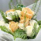 A bouquet of peach and white roses, succulents, and white chrysanthemums.