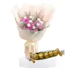 Bouquet of pink and white roses with a pack of Ferrero Rocher chocolates.