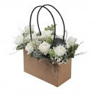 Brown paper flower bag with white roses and baby's breath.