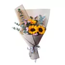 Bouquet of sunflowers and purple statice with eucalyptus leaves, wrapped in brown paper with a silver ribbon.