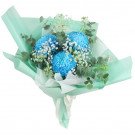 Blue chrysanthemums and baby's breath in mint green wrapping, tied with a ribbon.