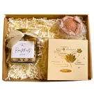 Gift box with jar of roasted nuts, lotus-shaped candy, and a decorative box with lotus design.