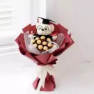 Graduation teddy bear and Ferrero Rocher chocolates in a burgundy bouquet with white ribbon.