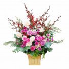 A wooden box arrangement of pink, purple, and white roses with red orchids and greenery.