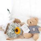 Teddy bear and sunflower bouquet with baby's breath, wrapped in brown paper.