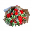 A bouquet of red roses and white flowers wrapped in brown paper with a red ribbon.