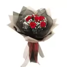 Bouquet of red roses with baby's breath and black and white wrapping.