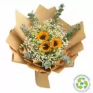 A bouquet of sunflowers, baby's breath, and eucalyptus, wrapped in brown paper.