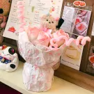 Plush & Posy: a bouquet with teddy bears and pink roses, next to a Maneki-neko cat figurine.