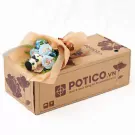 Bouquet of blue roses and a stuffed panda with a bow on a cardboard box labeled "POTICO.VN".