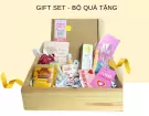 Wooden gift box with Hello Fresh body care products, including carrot body mask and bee knees scrub.