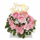 Pink roses, carnations, baby's breath, and greenery in a white box with a "Happy Birthday" topper.