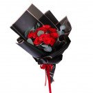 Red roses in black paper wrapping with red ribbon.