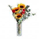Vase of sunflowers, red roses, and eucalyptus.